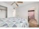 Cozy bedroom featuring a ceiling fan with ensuite bathroom and closet at 11403 N 57Th Dr, Glendale, AZ 85304