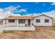 Charming single-story home featuring a brown roof, textured white exterior, and front porch at 11403 N 57Th Dr, Glendale, AZ 85304