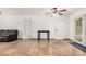 Open living room featuring tile floors, a ceiling fan, and multiple access points at 11403 N 57Th Dr, Glendale, AZ 85304