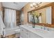 The primary bathroom features double sinks, a granite countertop and tiled bath-shower enclosure at 11431 N 37Th Pl, Phoenix, AZ 85028