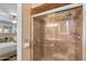 Elegant bathroom with a sleek glass shower featuring tile, a rain shower head, and modern accents at 11431 N 37Th Pl, Phoenix, AZ 85028