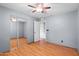 This bedroom features wood floors, a ceiling fan, and direct access to an adjacent room at 11431 N 37Th Pl, Phoenix, AZ 85028