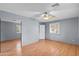 This bedroom features wood floors, a ceiling fan and a closet with mirrored doors at 11431 N 37Th Pl, Phoenix, AZ 85028