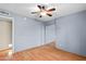 This bedroom has wood floors, a ceiling fan, and direct access to an adjacent room at 11431 N 37Th Pl, Phoenix, AZ 85028