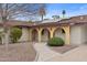 Inviting home showcasing desert landscaping, solar panels, and a covered entryway with arched columns at 11431 N 37Th Pl, Phoenix, AZ 85028