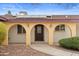 Home's entry with solar panels and a covered porch featuring elegant arched columns at 11431 N 37Th Pl, Phoenix, AZ 85028