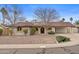 Charming single-story home with desert landscaping and a covered carport at 11431 N 37Th Pl, Phoenix, AZ 85028