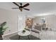 Cozy living room area featuring updated flooring and stylish furnishings under a ceiling fan at 11431 N 37Th Pl, Phoenix, AZ 85028