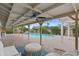 Cozy covered patio with ceiling fans offers a comfortable outdoor living space overlooking the pool at 11431 N 37Th Pl, Phoenix, AZ 85028