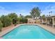 A beautiful swimming pool surrounded by landscaping with a patio and built in grill area at 11431 N 37Th Pl, Phoenix, AZ 85028