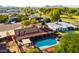 An appealing outdoor living space with a pool, patio, and solar panels nestled in a well-maintained backyard at 11431 N 37Th Pl, Phoenix, AZ 85028