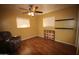 Comfortable bedroom with a ceiling fan, wood-look flooring, and plenty of natural light at 120 N 54Th St, Mesa, AZ 85205