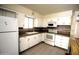 Cozy kitchen featuring white cabinets, laminate countertops, and stainless steel appliances at 120 N 54Th St, Mesa, AZ 85205