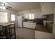 Cozy kitchen featuring white cabinets, laminate countertops, and stainless steel appliances at 120 N 54Th St, Mesa, AZ 85205