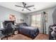 A bedroom with a black desk, a black leather gaming chair, and natural light from the window at 12162 W Dreyfus Dr, El Mirage, AZ 85335