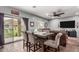 Dining table and seating area with view of the sliding glass doors to the backyard at 12162 W Dreyfus Dr, El Mirage, AZ 85335