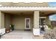 Inviting covered front porch with decorative door and space for seating at 12162 W Dreyfus Dr, El Mirage, AZ 85335