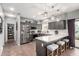 Bright kitchen featuring an island with seating, stainless steel appliances, and gray cabinets at 12162 W Dreyfus Dr, El Mirage, AZ 85335