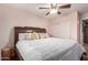 This bedroom has a light with a fan and a view of a closet with white sliding doors at 12162 W Dreyfus Dr, El Mirage, AZ 85335