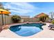 Sparkling pool surrounded by lush landscaping offers a refreshing oasis for outdoor enjoyment at 12162 W Dreyfus Dr, El Mirage, AZ 85335