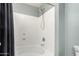 The shower has a white tub and shower head, with grey paint on the upper wall at 12162 W Dreyfus Dr, El Mirage, AZ 85335