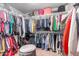 The walk-in closet is full of neatly hung clothes and purses on the top shelf at 12162 W Dreyfus Dr, El Mirage, AZ 85335