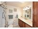 Cozy bathroom with a single sink vanity, tile floors, decorative towels and wall decor at 12418 W Galaxy Dr, Sun City West, AZ 85375