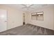 Bedroom features a ceiling fan, a closet, and a bright window at 12418 W Galaxy Dr, Sun City West, AZ 85375