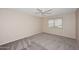 This bedroom has neutral walls, carpeting, and a ceiling fan at 12418 W Galaxy Dr, Sun City West, AZ 85375