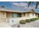 Inviting home exterior with manicured shrubbery, desert landscaping and a secure, decorative gate at 12418 W Galaxy Dr, Sun City West, AZ 85375