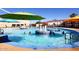 A leisure pool with fountains and colorful umbrellas, offering a relaxing and fun atmosphere for swimmers of all ages at 12418 W Galaxy Dr, Sun City West, AZ 85375