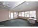 This sun room features a large window, and carpeted floors at 12418 W Galaxy Dr, Sun City West, AZ 85375