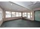 This sun room features a large window, and carpeted floors at 12418 W Galaxy Dr, Sun City West, AZ 85375