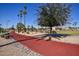 Scenic walking path with mature trees, lush greenery, and comfortable benches, inviting residents to enjoy the outdoors at 12418 W Galaxy Dr, Sun City West, AZ 85375