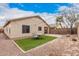 View of the backyard showing seating area, drought tolerant landscaping, and rear of house at 12530 W Jackson St, Avondale, AZ 85323