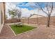 Serene backyard featuring a cozy seating area, low-maintenance landscaping, and string lights at 12530 W Jackson St, Avondale, AZ 85323