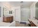 Bright bathroom featuring a soaking tub, walk-in shower, and double sink vanity with stylish fixtures and a framed mirror at 12530 W Jackson St, Avondale, AZ 85323