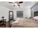 Spacious bedroom featuring hardwood floors, a ceiling fan, and a large mirror at 12530 W Jackson St, Avondale, AZ 85323