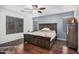 Spacious bedroom featuring hardwood floors, a ceiling fan, and a large window at 12530 W Jackson St, Avondale, AZ 85323