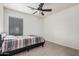 A cozy bedroom featuring neutral walls, carpet flooring, and a ceiling fan for added comfort at 12530 W Jackson St, Avondale, AZ 85323