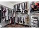 Spacious walk-in closet featuring custom shelving and multiple hanging areas, ideal for organization at 12530 W Jackson St, Avondale, AZ 85323