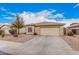 Single-story home featuring desert landscaping, tile roof, and a two-car garage at 12530 W Jackson St, Avondale, AZ 85323