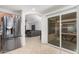 Bright kitchen with stainless steel fridge and view into the living room at 12530 W Jackson St, Avondale, AZ 85323