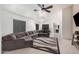 Living room with a gray sofa, carpet, and ceiling fan at 12530 W Jackson St, Avondale, AZ 85323