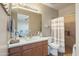 Full bathroom with a modern vanity, shower, and a peek into an adjoining workout room at 13432 N 154Th Ln, Surprise, AZ 85379