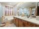 Well-lit bathroom featuring double sinks, a soaking tub, and glass-enclosed shower at 13432 N 154Th Ln, Surprise, AZ 85379