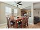 Bright dining room features a wood table and seating for eight, with natural light from large windows at 13432 N 154Th Ln, Surprise, AZ 85379