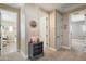 Hallway with multiple doorways, leading to other rooms, with a small accent table and decorative mirror at 13432 N 154Th Ln, Surprise, AZ 85379