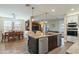 Open kitchen featuring a large center island with bar seating, granite countertops, and stainless steel appliances at 13432 N 154Th Ln, Surprise, AZ 85379