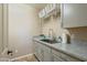 Laundry room featuring gray cabinets, granite countertops, and stainless steel sink at 13432 N 154Th Ln, Surprise, AZ 85379